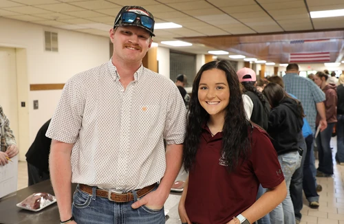 Man and woman smiling.